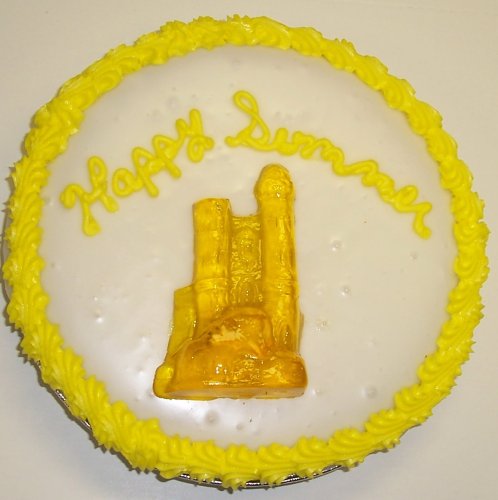 Cookie Cake Pie With Chocolate White Chip Cookie and Hazelnut Cake 9-topped With Tropical Punch Sand Castle Gummie logo