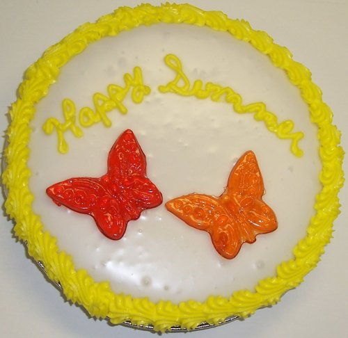 Cookie Cake Pie With Pecan Cookie and Chocolate Cake 9-topped With Cherry and Orange Butterfly Lollipop logo