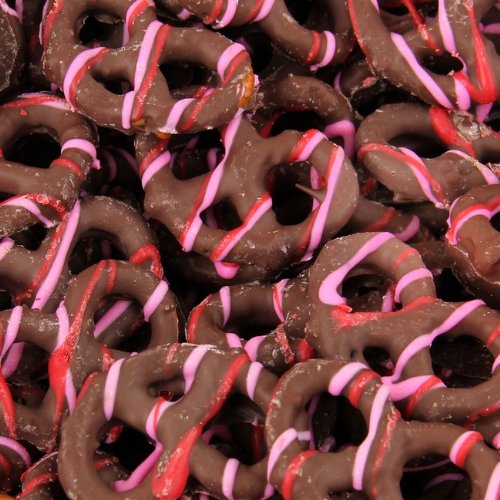 Gourmet Red Pink Drizzled Delights Chocolate Pretzels 8 Oz Box logo