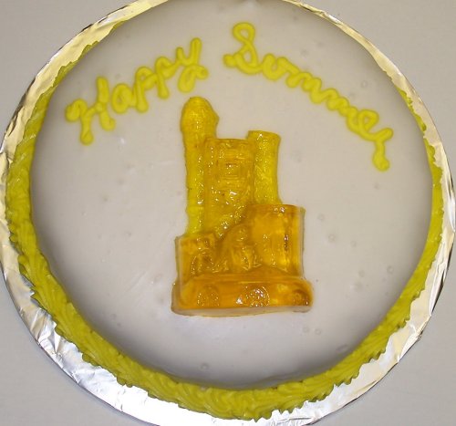 Lemon Decorated Cake Single Layer 8 Roundtopped With Tropical Punch Sand Castle Gummie logo