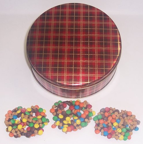 Scott’s Cakes 1 Lb. Dark Chocolate Covered Pretzel With M & M’s & Peanut Butter Chips In A Plaid Tin logo