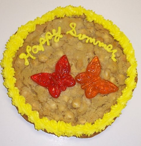 Scott’s Cakes 2 Lb. Chocolate Chip Cookie Cake With Grape and Orange Butterfly Lollipop logo