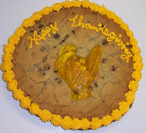Scott’s Cakes 2 Lb. Chocolate Chip Cookie Cake With Gummie Turkey Golden Yellow Trim logo