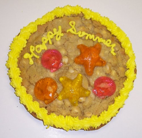 Scott’s Cakes 2 Lb. Chocolate Chip Cookie Cake With Mixed Fruit Sea Shell and Starfish Gummies logo