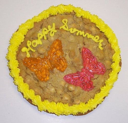 Scott’s Cakes 2 Lb. Chocolate Chip Cookie Cake With Tropical Punch and Orange Butterfly Gummie logo