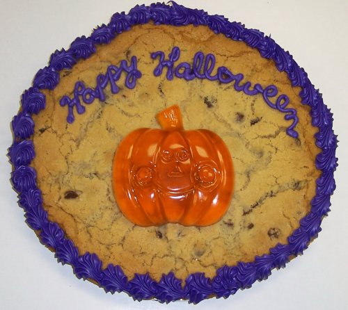 Scott’s Cakes 2 Lb. M & M Cookie Cake With Gummie Pumpkin Purple Trim logo